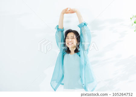 A middle-aged woman in a light blue shirt A middle-aged woman in a light blue shirt 105264752
