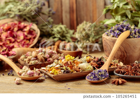 Various dried medicinal plants, herbs, and flowers on an old wooden background. Various dried medicinal plants, herbs, and flowers on an old wooden background. 105265451