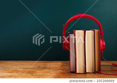 audio book concept with stack of books and headphones. 105266669