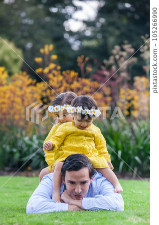 Sweet girls having fun outdoors with their father. Fatherhood concept. Happiness concept. Family concept 105266990