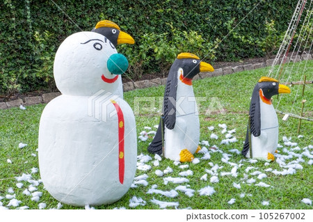 One snowman and three penguins, garden sculptures on the lawn. One snowman and three penguins, garden sculptures on the lawn. 105267002