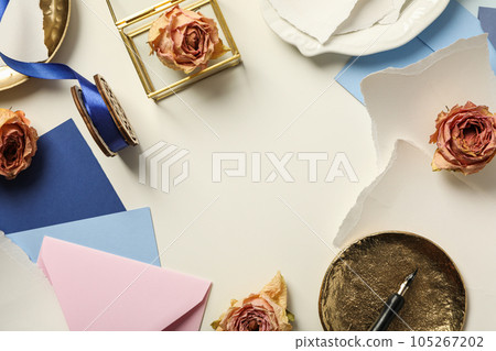 Pieces of paper, roses and golden plates on white background, space for text Pieces of paper, roses and golden plates on white background, space for text 105267202