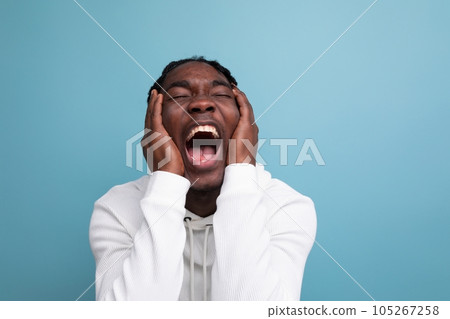 happy surprised american 20s man with dreadlocks on background with copy space 105267258