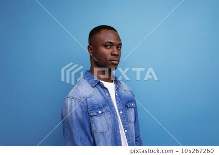 portrait of a well-groomed emotional young attractive african man dressed casually in denim 105267260