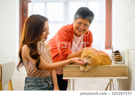 A senior with her daughter is depicted in a happy portrait at their home 105267337