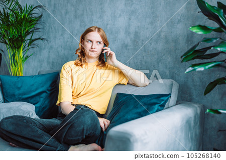 Sad 30s woman has difficult phone talk hold gadget by ear listen to unexpected bad news think on answer. Compassionate young lady support friend by cell try to help ponder on advice.  105268140