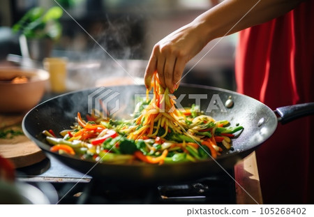 Stirring vegetables in a frying pan 105268402