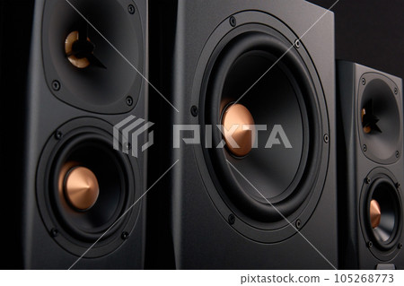 Multimedia acoustic sound speakers. Sound audio system with two satellites and subwoofer on dark background. Stereo system for listening music 105268773