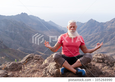 Senior man greeting sunset Senior man greeting sunset 105268990