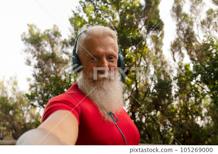 Bearded senior using mobile phone outdoor Bearded senior using mobile phone outdoor 105269000