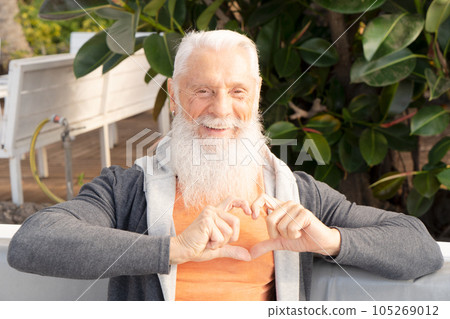 Smeling senior man with heart 105269012