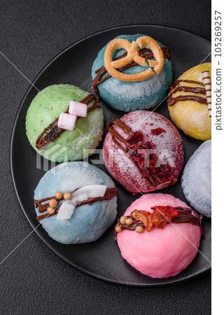 Delicious sweet colorful mochi desserts or ice cream with rice dough and toppings Delicious sweet colorful mochi desserts or ice cream with rice dough and toppings 105269257