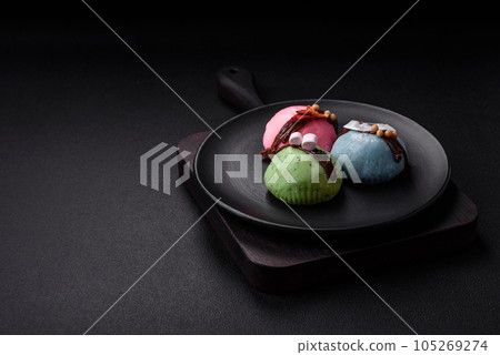 Delicious sweet colorful mochi desserts or ice cream with rice dough and toppings Delicious sweet colorful mochi desserts or ice cream with rice dough and toppings 105269274