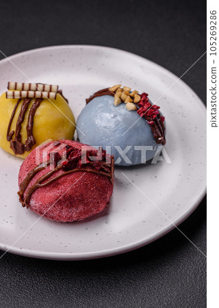 Delicious sweet colorful mochi desserts or ice cream with rice dough and toppings Delicious sweet colorful mochi desserts or ice cream with rice dough and toppings 105269286
