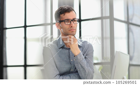 Worried businessman in office. Thoughtful man looking through the window. Worried businessman in office. Thoughtful man looking through the window. 105269501