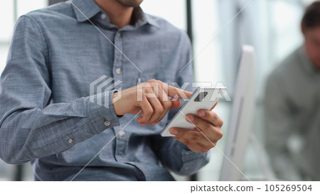 businessman using mobile phone to send message in office 105269504