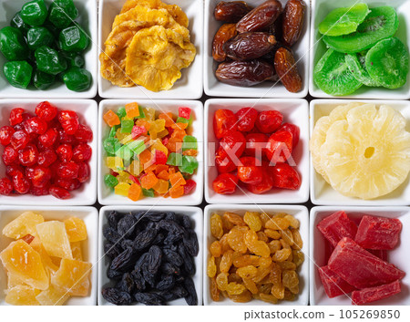 Group of dried and candied fruit in bowl 105269850