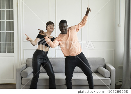 Couple of young man and woman dancing at home 105269968