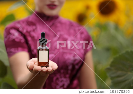Charming women presenting a natural cosmetic on her hand, mock-up. Copy space. 105270295