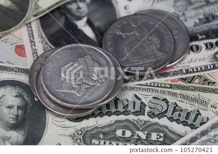 Old west US banknotes and silver certificates with silver dollar coins 105270421