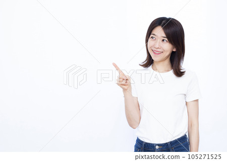 A woman in her thirties who raises her index finger in front of a white background A woman in her thirties who raises her index finger in front of a white background 105271525