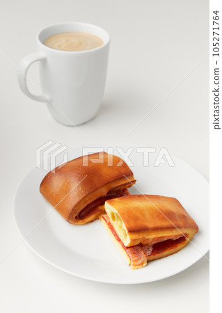 Lanche misto traditional portuguese sandwich with cheese and chorizo. Tasty breakfast over white background Lanche misto traditional portuguese sandwich with cheese and chorizo. Tasty breakfast over white background 105271764