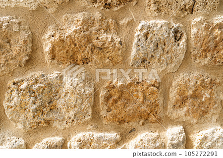 Old beige stone wall background texture close up. Castle wall surface, antique natural stonewall Old beige stone wall background texture close up. Castle wall surface, antique natural stonewall 105272291