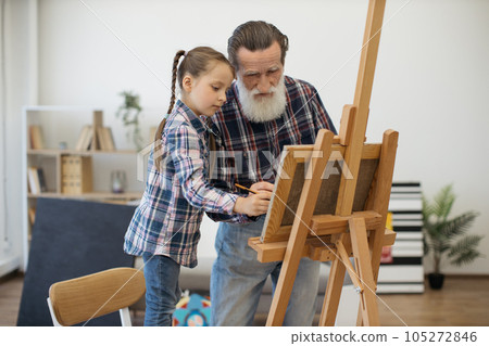 Grandpa teaching color combination rules to child in studio 105272846
