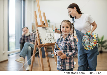 Child with brushes taking part in creativity at home studio 105273210