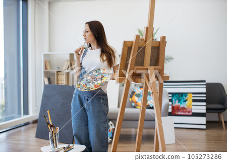 Self-employed female painter using art studio for work 105273286