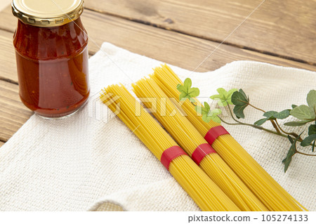 Bottled tomato sauce and pasta wood grain background 105274133