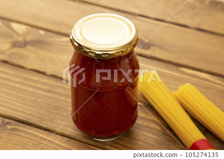 Bottled tomato sauce and pasta wood grain background 105274135