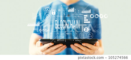 Blockchain theme with man using a tablet 105274566