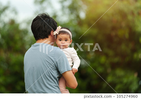 father holding infant baby in park father holding infant baby in park 105274960