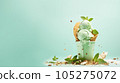 Advertising shot, green nut ice cream with pistachios in a cup top view isolated on light green background. High quality illustration 105275072