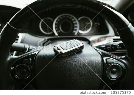 Car steering wheel with keyless remote in the car, Automotive concept. Car steering wheel with keyless remote in the car, Automotive concept. 105275370
