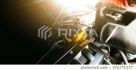 Car mechanic pouring engine oil into engine, changing engine oil, car mechanic working Car mechanic pouring engine oil into engine, changing engine oil, car mechanic working 105275377