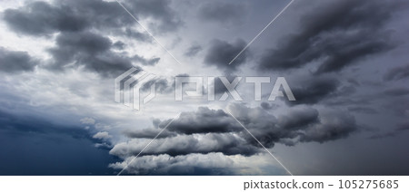 The dark sky had clouds gathered to the left and a strong storm before it rained.Bad weather sky. 105275685