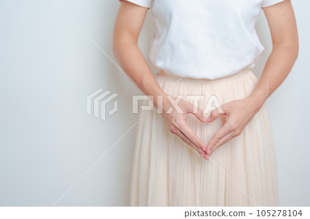 Woman hand heart shape over abdomen. Ovarian and Cervical cancer, Endometriosis, Hysterectomy, Uterine fibroids, Reproductive, menstruation, Stomach, Pregnancy and Sexual Transmitted disease concept Woman hand heart shape over abdomen. Ovarian and Cervical cancer, Endometriosis, Hysterectomy, Uterine fibroids, Reproductive, menstruation, Stomach, Pregnancy and Sexual Transmitted disease concept 105278104