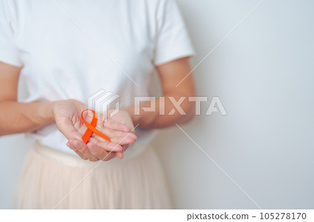 woman with Orange Ribbon for Leukemia, Kidney cancer day, world Multiple Sclerosis, CRPS, Self Injury Awareness month. Healthcare and word cancer day concept 105278170