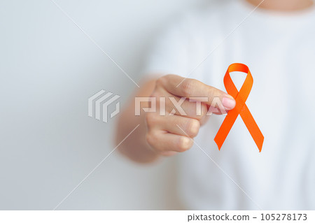 woman with Orange Ribbon for Leukemia, Kidney cancer day, world Multiple Sclerosis, CRPS, Self Injury Awareness month. Healthcare and word cancer day concept woman with Orange Ribbon for Leukemia, Kidney cancer day, world Multiple Sclerosis, CRPS, Self Injury Awareness month. Healthcare and word cancer day concept 105278173