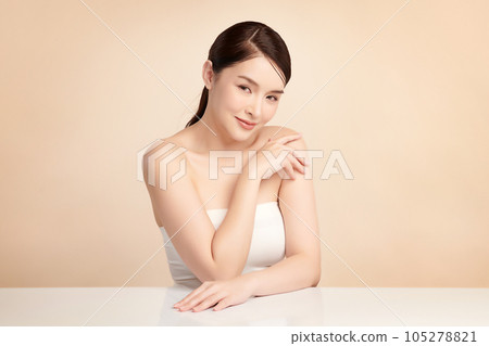 Beautiful young asian woman with clean fresh skin on beige background, Face care, Facial treatment, Cosmetology, beauty and spa, Asian women portrait. 105278821