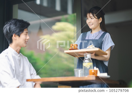 Young woman working at a fashionable cafe in the suburbs Young woman working at a fashionable cafe in the suburbs 105279706