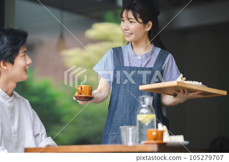 Young woman working at a fashionable cafe in the suburbs 105279707