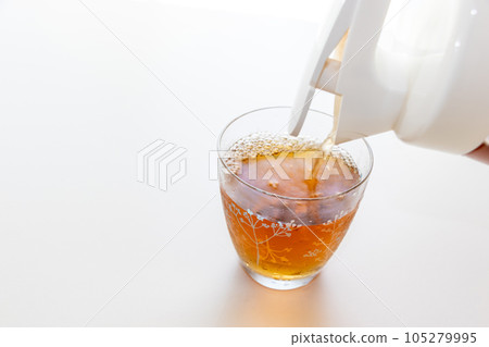 Pouring cold barley tea into a glass Pouring cold barley tea into a glass 105279995