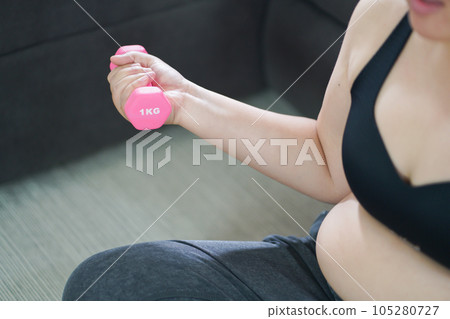 Overweight woman exercising for weight loss. exercise with dumbbells in stretching positions at home in the living room Cheerful Fat woman diet healthy lifestyle concept. Overweight woman exercising for weight loss. exercise with dumbbells in stretching positions at home in the living room Cheerful Fat woman diet healthy lifestyle concept. 105280727