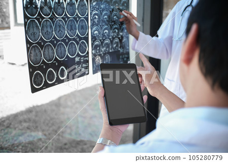 Professional medical doctor in white uniform gown coat.Education people and medicine concept close up of happy doctors with tablet and papers at seminar or hospital healthcare 105280779