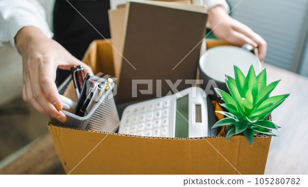 Business woman sending resignation letter and packing Stuff Resign Depress or carrying business cardboard box by desk in office. Change of job or fired from company Business woman sending resignation letter and packing Stuff Resign Depress or carrying business cardboard box by desk in office. Change of job or fired from company 105280782