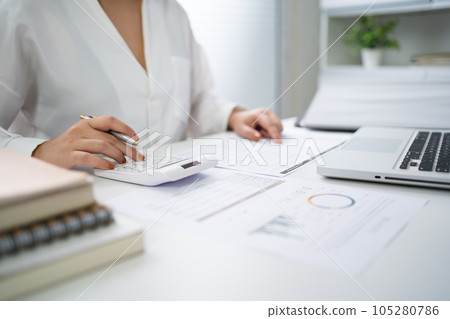 Business woman Accountant investment risk analysis. saving money for Stock market trading with calculator. Accountancy Concept. Business woman Accountant investment risk analysis. saving money for Stock market trading with calculator. Accountancy Concept. 105280786