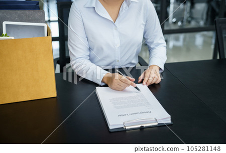 Business woman sending resignation letter to boss and Holding Stuff Resign Depress or carrying cardboard box by desk in office Business woman sending resignation letter to boss and Holding Stuff Resign Depress or carrying cardboard box by desk in office 105281148